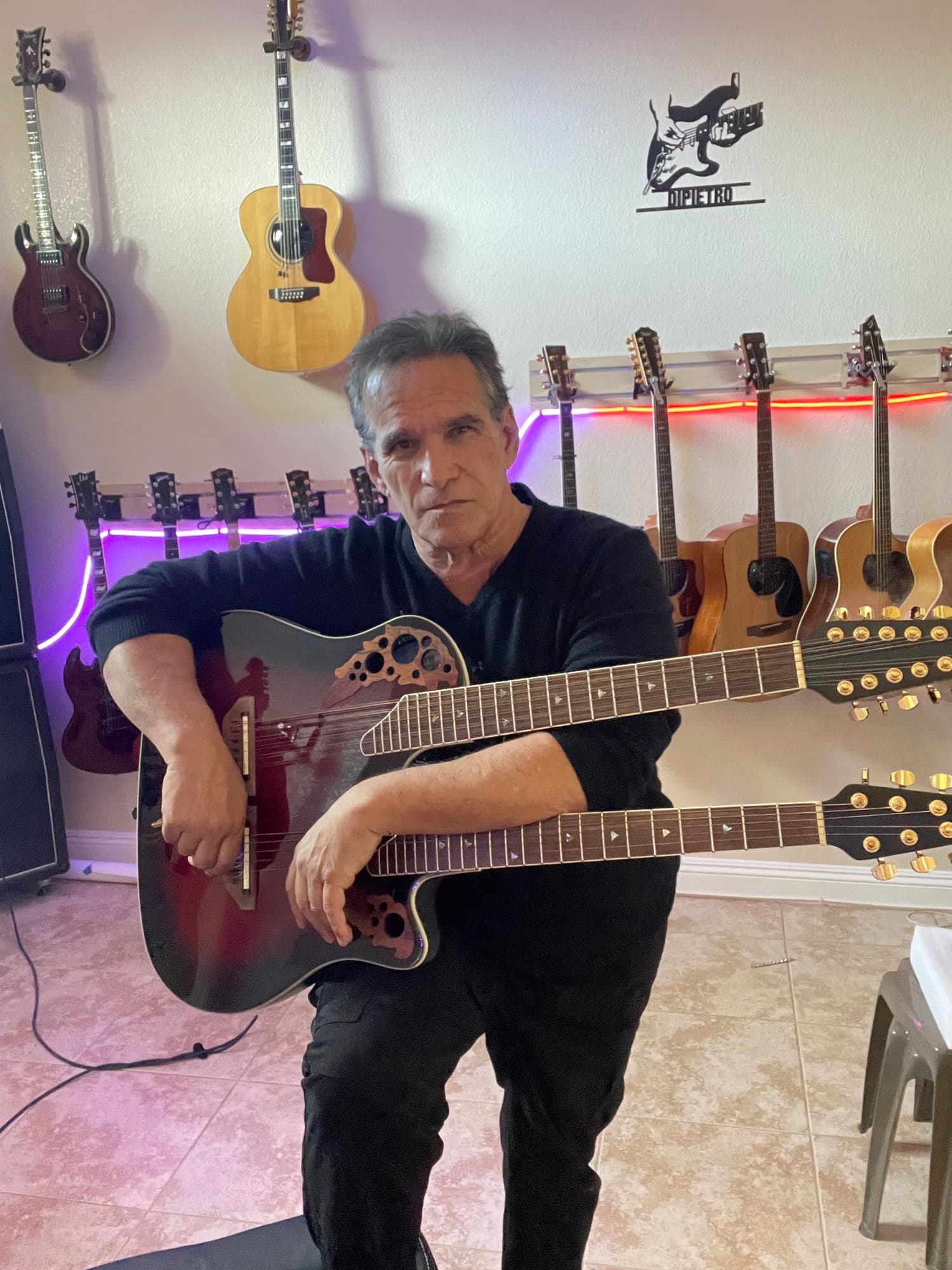Mark with guitars and purple lighting